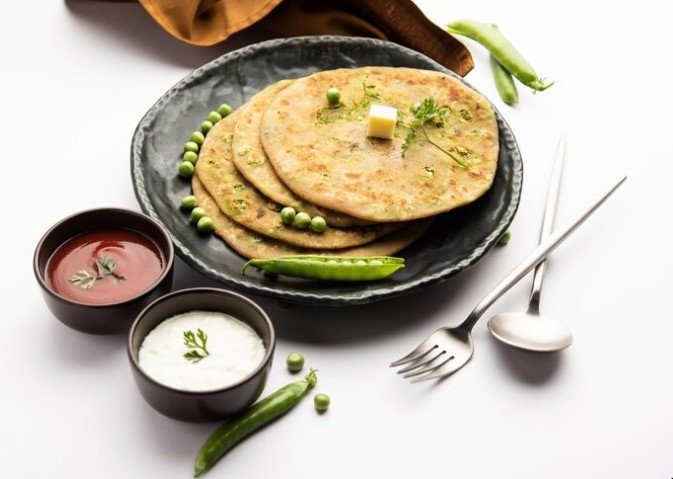 Delicious Indian paratha served with curd and chutney on a plate